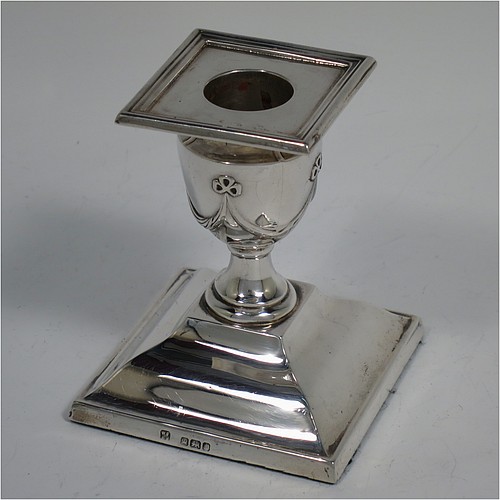 An Antique Victorian Sterling Silver very pretty pair of small candlesticks, having neoclassical style decoration with rectangular bases, with hand-chased bows and swags, and removable nozzles with applied reeded borders. Made by William Angus Fraser of Sheffield in 1894. The dimensions of these fine hand-made antique silver candlesticks are height 8 cms (3.25 inches), and the bases are 7 cms (2.75 inches) square.    