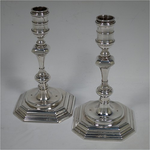 A very handsome Sterling Silver pair of cast candlesticks in a George I style, having octagonal baluster bodies, and sitting on hexagonal bases. Made in London in 1992. The dimensions of these fine hand-made cast silver table candlesticks are height 17 cms (6.75 inches), and the bases are 10 cms (4 inches) square.    