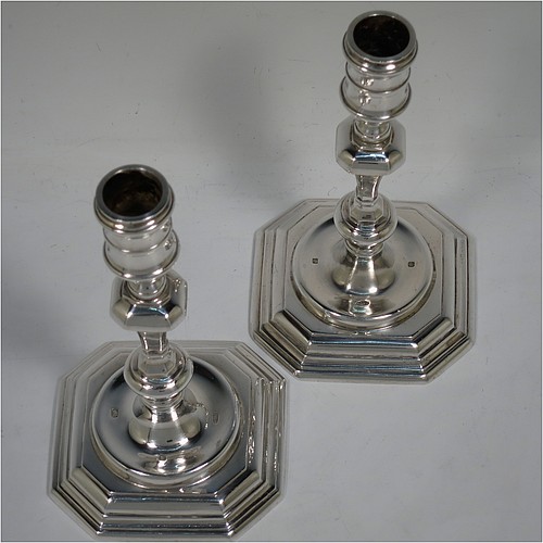 A very handsome Sterling Silver pair of cast candlesticks in a George I style, having octagonal baluster bodies, and sitting on hexagonal bases. Made in London in 1992. The dimensions of these fine hand-made cast silver table candlesticks are height 17 cms (6.75 inches), and the bases are 10 cms (4 inches) square.    