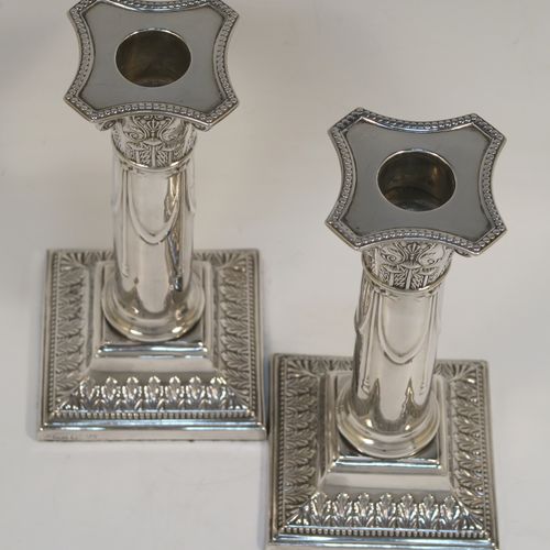 A very pretty Antique Edwardian Sterling Silver pair of candlesticks, in a Neoclassical style with hand-chased bows, swags, and acanthus leaves, with bead-edged borders, removable nozzles, and square bases. This beautiful pair of antique silver candlesticks were made by Thomas Scot of Sheffield in 1908. The dimensions of this fine pair of hand-made antique silver candlesticks are height 16 cms (6.3 inches), and the bases are 8 cms (3.25 inches) square.   