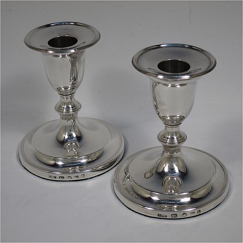 A very handsome pair of Antique Georgian Sterling Silver candlesticks, in a very plain round style, having baluster bodies with hand-chased reeded borders and original removable nozzles. Made by Nathaniel Smith and Co., of Sheffield in 1804. The dimensions of these fine hand-made antique silver candlesticks are height 11.5 cms (4.5 inches), and the bases are 10 cms (4 inches) in diameter.    