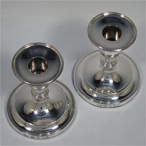 A very handsome pair of Antique Georgian Sterling Silver candlesticks, in a very plain round style, having baluster bodies with hand-chased reeded borders and original removable nozzles. Made by Nathaniel Smith and Co., of Sheffield in 1804. The dimensions of these fine hand-made antique silver candlesticks are height 11.5 cms (4.5 inches), and the bases are 10 cms (4 inches) in diameter.    