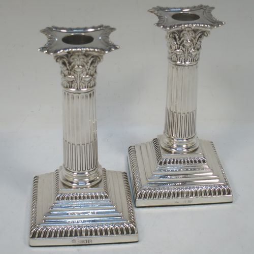 A very pretty pair of Antique Victorian Sterling Silver of Corinthian style candlesticks, having traditional gadroon borders, acanthus-leaf capitals, fluted columns, removable nozzles, and square stepped bases. Made by William Hutton of London in 1901. The dimensions of this fine hand-made pair of antique silver candlesticks are height 16 cms (6.25 inches), and the bases are 8.5 cms (3.3 inches) square.  