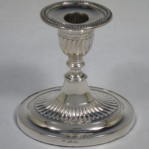 A very pretty pair of Antique Edwardian Sterling Silver candlesticks, having oval bodies with hand-chased half-fluted decoration, original removable nozzles with applied leaf-style borders. Made by Fordham and Faulkner of Sheffield in 1906. The dimensions of these fine hand-made antique silver candlesticks are height 11 cms (4.25 inches), and the bases are 11 cms (4.25 inches) long.    