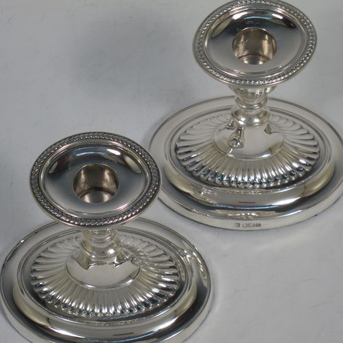 A very pretty pair of Antique Edwardian Sterling Silver candlesticks, having oval bodies with hand-chased half-fluted decoration, original removable nozzles with applied leaf-style borders. Made by Fordham and Faulkner of Sheffield in 1906. The dimensions of these fine hand-made antique silver candlesticks are height 11 cms (4.25 inches), and the bases are 11 cms (4.25 inches) long.    