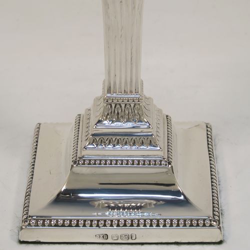 A very pretty pair of Antique Edwardian Sterling Silver of Neoclassical style candlesticks, having bead-edged borders, fluted columns, removable nozzles, and square stepped bases. These beautiful antique silver candlesticks were made by Roberts and Belk of Sheffield in 1909. The dimensions of this fine hand-made pair of antique silver candlesticks are height 18 cms (7 inches), and the bases are 8 cms (3.25 inches) square.   