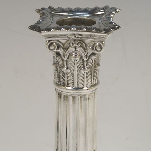 A very handsome and bold pair of Sterling Silver of Corinthian style candlesticks, having traditional gadroon borders, acanthus-leaf capitals, fluted columns, removable nozzles, and square stepped bases. These beautiful silver candlesticks were made by Hawksworth Eyre and Co., of Sheffield in 1923. The dimensions of this fine hand-made pair of silver candlesticks are height 19.5 cms (7.75 inches), and the bases are 8.5 cms (3.3 inches) square.   