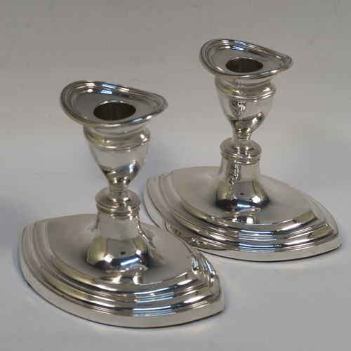 A very handsome pair of Antique Sterling Silver candlesticks, having plain oval boat-shaped bodies with reeded borders, and original removable nozzles. These elegant antique silver candlesticks were made by Williams Ltd., of Birmingham in 1911. The dimensions of these fine hand-made antique silver candlesticks are height 11.5 cms (4.5 inches), and the bases are 14 cms (5.5 inches) long.   