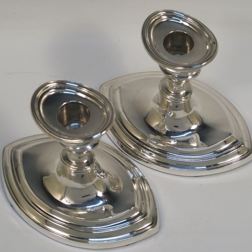 A very handsome pair of Antique Sterling Silver candlesticks, having plain oval boat-shaped bodies with reeded borders, and original removable nozzles. These elegant antique silver candlesticks were made by Williams Ltd., of Birmingham in 1911. The dimensions of these fine hand-made antique silver candlesticks are height 11.5 cms (4.5 inches), and the bases are 14 cms (5.5 inches) long.   