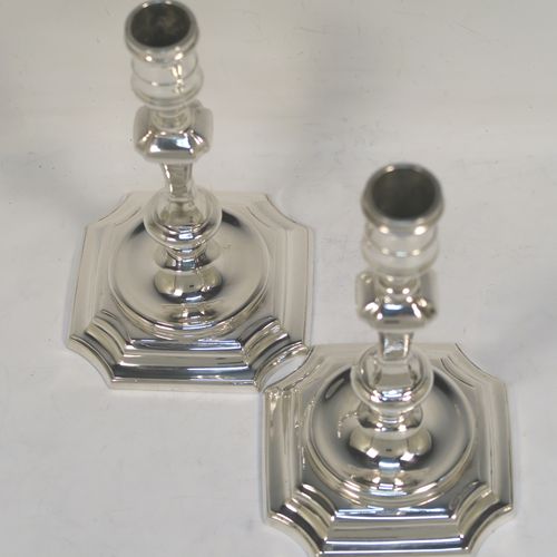 A very handsome pair of cast Sterling Silver candlesticks in a George I style, having plain cut-cornered and panelled baluster bodies. These elegant cast silver candlesticks were made by J. B. Chatterley and Sons Ltd., of Birmingham in 1974. The dimensions of this fine pair of hand-made cast sterling silver table candlesticks are height 15 cms (6 inches), the bases are 9 cms (3.5 inches) square, and the total weight is 618g (20 troy ounces).   