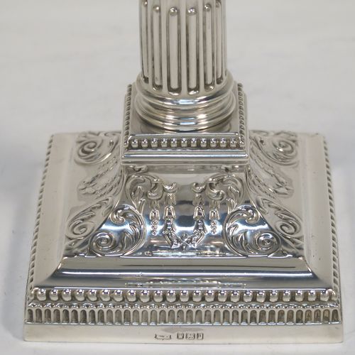 A very pretty pair of Antique Edwardian Sterling Silver of Corinthian style candlesticks, having bead-edged borders, acanthus-leaf capitals, fluted columns, removable nozzles, and square stepped bases. These beautiful antique silver candlesticks were made by James Dixon and Sons of Sheffield in 1907. The dimensions of this fine hand-made pair of antique silver candlesticks are height 17 cms (6.75 inches), and the bases are 9 cms (3.5 inches) square.   