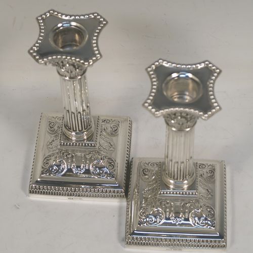 A very pretty pair of Antique Edwardian Sterling Silver of Corinthian style candlesticks, having bead-edged borders, acanthus-leaf capitals, fluted columns, removable nozzles, and square stepped bases. These beautiful antique silver candlesticks were made by James Dixon and Sons of Sheffield in 1907. The dimensions of this fine hand-made pair of antique silver candlesticks are height 17 cms (6.75 inches), and the bases are 9 cms (3.5 inches) square.   