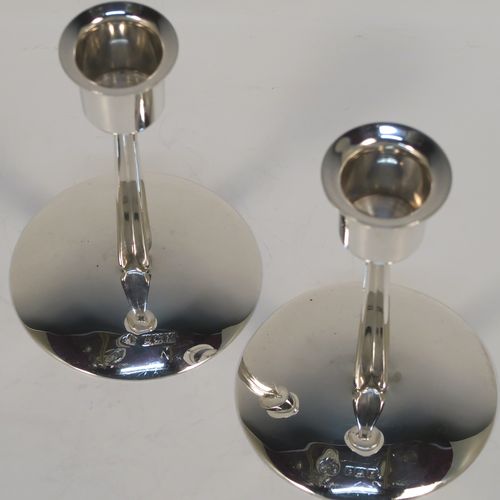 A very unusual Sterling Silver pair of modernistic style candlesticks, having plain round nozzles, plain cross-section style columns, and sitting on plain round bases. These very individual silver candlestick holders were made by Elkington and Co., of Birmingham in 1961. The dimensions of these fine hand-made silver candlesticks are height 11 cms (4.3 inches), diameter at base 7.5 cms (3 inches), and with a total weight of approx. 163g (5.3 troy ounces). Please note that these candlesticks are not loaded.   