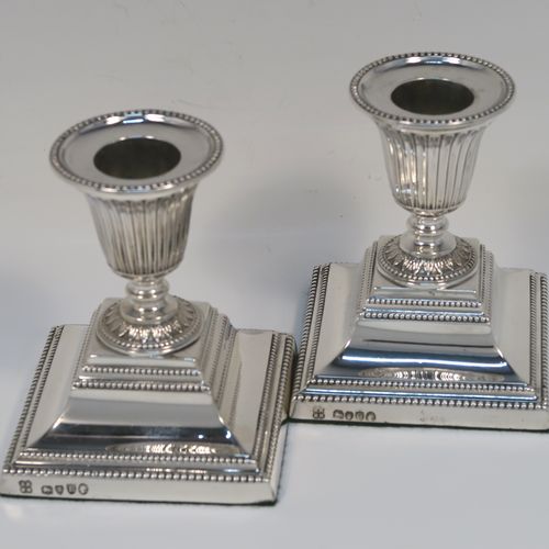 A small but very pretty pair of Antique Victorian Sterling Silver candlesticks, having urn-shaped bodies with fluted and anthemion leaf decoration, with applied bead-edged borders, sitting on square bases, and original removable nozzles. These beautiful silver candlesticks were made by Richard Hodd and Sons of London in 1877. The dimensions of these fine hand-made antique silver candlesticks are height 9 cms (3.5 inches), and the bases are 7.5 cms (3 inches) square.   