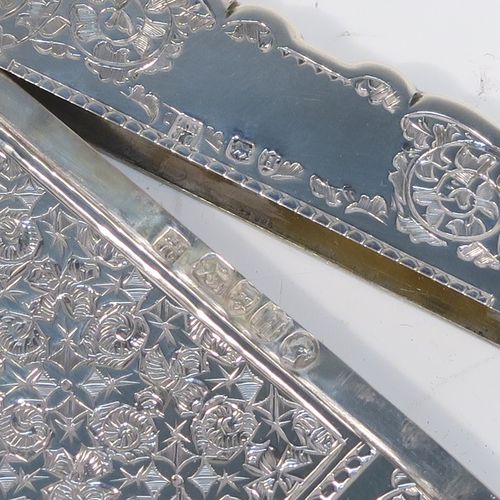 A very pretty Antique Victorian Sterling Silver calling card case, having a shaped rectangular body with pristine hand-engraved floral and Ivy decoration, and a side-hinged lid. This beautiful silver card case was made by Alfred Hall and John Goode of London in 1883. The dimensions of this fine hand-made antique silver card case are length 10 cms (4 inches), width 7 cms (2.75 inches), and it weighs approx. 64g (2 troy ounces).   