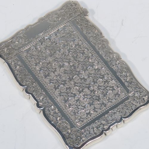 A very pretty Antique Victorian Sterling Silver calling card case, having a shaped rectangular body with pristine hand-engraved floral and Ivy decoration, and a side-hinged lid. This beautiful silver card case was made by Alfred Hall and John Goode of London in 1883. The dimensions of this fine hand-made antique silver card case are length 10 cms (4 inches), width 7 cms (2.75 inches), and it weighs approx. 64g (2 troy ounces).   