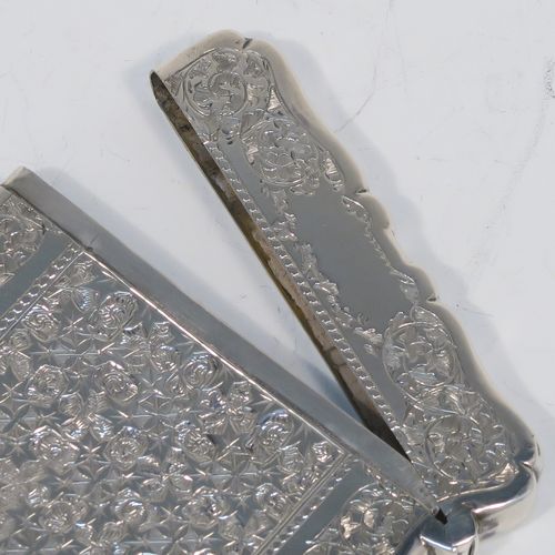 A very pretty Antique Victorian Sterling Silver calling card case, having a shaped rectangular body with pristine hand-engraved floral and Ivy decoration, and a side-hinged lid. This beautiful silver card case was made by Alfred Hall and John Goode of London in 1883. The dimensions of this fine hand-made antique silver card case are length 10 cms (4 inches), width 7 cms (2.75 inches), and it weighs approx. 64g (2 troy ounces).   