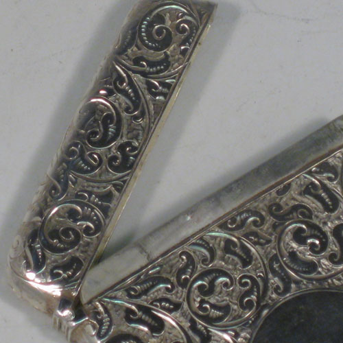 Antique Victorian sterling silver calling card case, having a rectangular body with hand-engraved floral decoration, a vacant central cartouch, and a side-hinged lid. Made in  Birmingham in 1889. The dimensions of this fine hand-made silver card case are length 10 cms (4 inches), width 7 cms (2.75 inches), and it weighs approx. 61g (2 troy ounces). Please note that this card case has a push button mechanism that is not working, but it is not required to make the lid secure.  