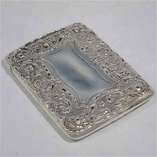 A very pretty Antique Edwardian Sterling Silver Art Nouveau card case, having a hand-chased rectangular body with floral and scroll decoration, a hanged lid, and two vacant cartouches on either side. Made by Cornelius Saunders and Frank Shepherd of Birmingham in 1905. The dimensions of this fine hand-made antique silver card case are length 9.5 cms (3.75 inches), width 7 cms (2.75 inches), and it weighs approx. 69g (2.2 troy ounces).