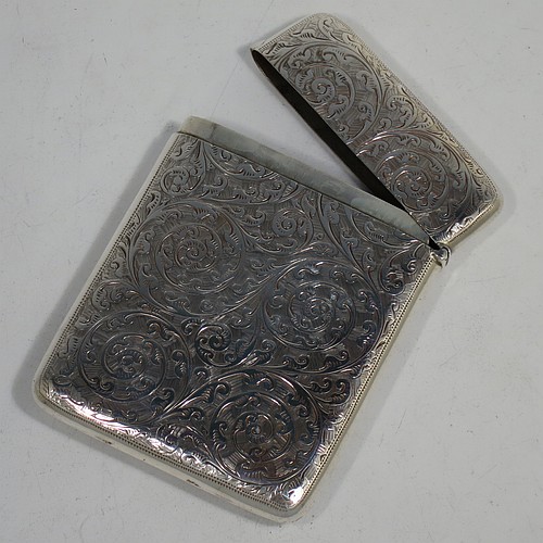 A very pretty Antique Victorian Sterling Silver calling card case, having a rectangular body with rounded shoulders, hand-engraved floral decoration, a vacant central cartouche on one side, and a side-hinged lid. Made by George Loveridge of Birmingham in 1898. The dimensions of this fine hand-made antique silver card case are length 10 cms (4 inches), width 7.5 cms (3 inches), and it weighs approx. 88g (2.8 troy ounces).   