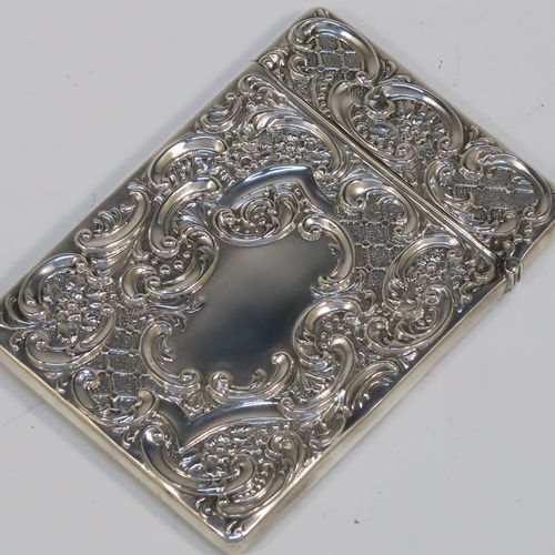 A very pretty Antique Edwardian Sterling Silver Castle-Top card case, having a hand-chased rectangular body with floral and scroll decoration, together with a scene of Royal Windsor Castle on one side, a hanged lid, and a vacant cartouches on the other side. This beautiful antique silver card case was made by Crisford and Norris of Birmingham in 1906. The dimensions of this fine hand-made antique silver card case are length 10 cms (4 inches), width 7 cms (2.75 inches), and it weighs approx. 58g (1.9 troy ounces).   