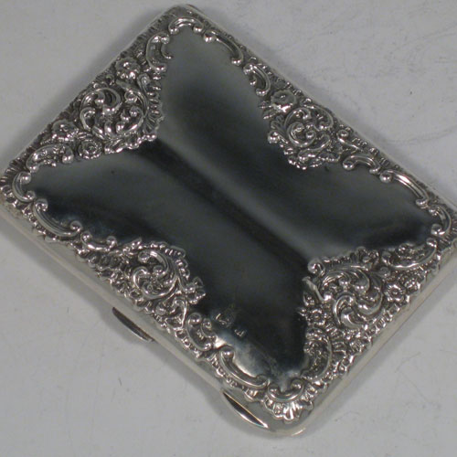 Antique Victorian sterling silver card case and aide de memoire, having a rectangular shaped body with hand-chased floral decoration, with thumb-piece and catch, and a hinged opening revealing an original interior lined with satin and having a revolving pencil with ivory marker card. Made by Henry Miller of Birmingham in 1900. The dimensions of this fine hand-made silver case are length 10 cms (4 inches), width 8 cms (3 inches), and it weighs approx. 100g (3.2 troy ounces).   