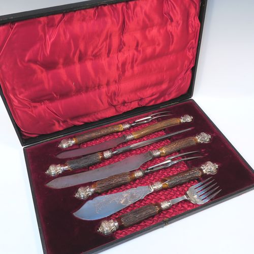 A very handsome, large, and complete seven-piece Antique Victorian Silver Plated and deer antler horn meat carving set with fish servers, consisting of two forks with working guards, two knives, one sharpening steel, one fish serving fork fork, and one fish knife with hand-engraved gingko and fern leaves, all with bone antler handles and silver ferrules with hand-chased fluting and floral decoration, all in their original maroon velvet and crimson silk lined presentation box. This beautiful original carving set was made in ca. 1895 with a design registration mark. The dimensions of this fine hand-made antique silver and antler bone handled carving set are length of longest knife 39 cms (15.3 inches), and length of forks 29 cms (11.5 inches).   