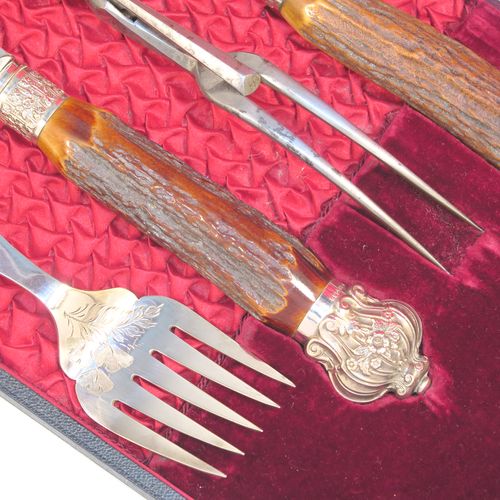 A very handsome, large, and complete seven-piece Antique Victorian Silver Plated and deer antler horn meat carving set with fish servers, consisting of two forks with working guards, two knives, one sharpening steel, one fish serving fork fork, and one fish knife with hand-engraved gingko and fern leaves, all with bone antler handles and silver ferrules with hand-chased fluting and floral decoration, all in their original maroon velvet and crimson silk lined presentation box. This beautiful original carving set was made in ca. 1895 with a design registration mark. The dimensions of this fine hand-made antique silver and antler bone handled carving set are length of longest knife 39 cms (15.3 inches), and length of forks 29 cms (11.5 inches).   