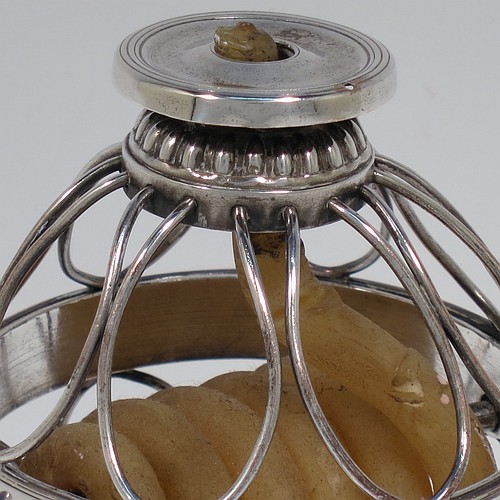 An Antique Georgian Old Sheffield Silver Plated wax-jack chamber-stick in a globe style, having a coiled wax mounted in a spherical boy with a wire-work frame, sitting on a plain round pedestal foot, with hand-chased reeded borders, all in original condition. Made in ca. 1800. The dimensions of this fine hand-made antique Old Sheffield silver-plated waxjack chamberstick are height 13.5 cms (5.5 inches), and diameter 7.5 cms (3 inches).
	   