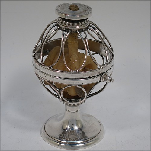 An Antique Georgian Old Sheffield Silver Plated wax-jack chamber-stick in a globe style, having a coiled wax mounted in a spherical boy with a wire-work frame, sitting on a plain round pedestal foot, with hand-chased reeded borders, all in original condition. Made in ca. 1800. The dimensions of this fine hand-made antique Old Sheffield silver-plated waxjack chamberstick are height 13.5 cms (5.5 inches), and diameter 7.5 cms (3 inches).
	   