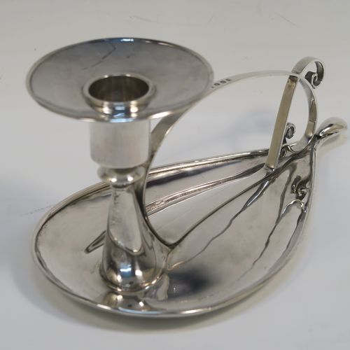 A very individual Scottish Sterling Silver modernistic style chamber-stick, having a plain oval leaf-form body, with a scroll-work handle, a plain round fixed nozzle, and sitting on a flat base. This unusual silver chamberstick was made in Edinburgh in 2008. The dimensions of these fine hand-made silver chambersticks are length 18 cms (7 inches), width 10 cms (4 inches), height 9 cms (3.5 inches), and it weighs approx. 162g (5.2 troy ounces).   