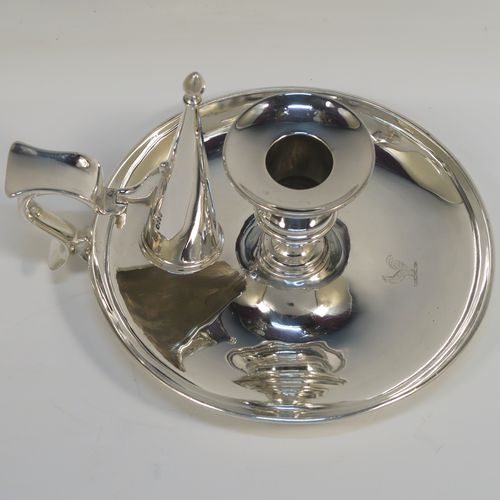 A very handsome pair of Antique Victorian Sterling Silver chambersticks, having very plain round bodies, with original removable nozzles and dunce-cap snuffers. These elegant silver chambersticks were made by Robert Garrard (the Royal Goldsmith of the time) of London in 1866. The dimensions of these fine hand-made antique silver chamber-sticks are height 10 cms (4 inches), diameter 15 cms (6 inches), and they weigh a total of approx. 812g (26 troy ounces). Please note that these items are part-crested.