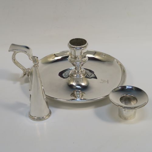 A very handsome pair of Antique Victorian Sterling Silver chambersticks, having very plain round bodies, with original removable nozzles and dunce-cap snuffers. These elegant silver chambersticks were made by Robert Garrard (the Royal Goldsmith of the time) of London in 1866. The dimensions of these fine hand-made antique silver chamber-sticks are height 10 cms (4 inches), diameter 15 cms (6 inches), and they weigh a total of approx. 812g (26 troy ounces). Please note that these items are part-crested.