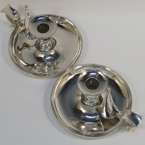 A very handsome pair of Antique Victorian Sterling Silver chambersticks, having very plain round bodies, with original removable nozzles and dunce-cap snuffers. These elegant silver chambersticks were made by Robert Garrard (the Royal Goldsmith of the time) of London in 1866. The dimensions of these fine hand-made antique silver chamber-sticks are height 10 cms (4 inches), diameter 15 cms (6 inches), and they weigh a total of approx. 812g (26 troy ounces). Please note that these items are part-crested.