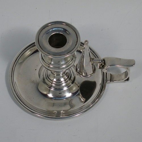 An Antique Victorian Sterling Silver small chamber-stick, having a plain body with a round base, a cast plain scroll handle, an original removable dunce-cap extinguisher, an original removable nozzle, and with applied reed-edged borders. Made by Samuel Hayne and Dudley Cater of London in 1850. The dimensions of this fine hand-made antique silver chamberstick are diameter 10 cms (4 inches), height 7 cms (2.75 inches), and it weighs approx. 179g (5.8 troy ounces).    