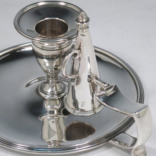 An Antique Georgian Sterling Silver chamber-stick, having a round base, a cast plain scroll handle, an original removable dunce-cap extinguisher, an original removable nozzle, and with applied reed-edged borders. Made by Samuel & George Whitford of London in 1806. The dimensions of this fine hand-made antique silver chamberstick are diameter 13.5 cms (5.25 inches), height 9.5 cms (3.75 inches), and it weighs approx. 326g (10.5 troy ounces).   