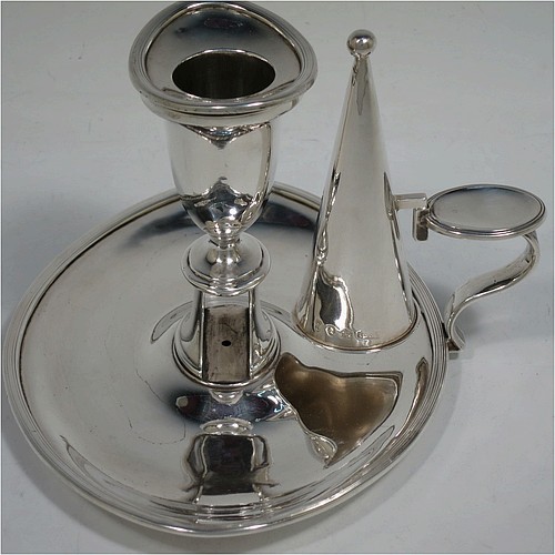 A very handsome pair of Antique Georgian Sterling Silver chamber-sticks, having plain oval bodies, scroll handles with thumb-pieces, original removable dunce-cap extinguishers, original removable nozzles, and with applied reed-edged borders. Made by James Ellis and Co., of Sheffield in 1795. The dimensions of these fine hand-made antique silver chambersticks are length 17 cms (6.75 inches), width 13 cms (5 inches), height 10 cms (4 inches), and they weigh a total of approx. 580g (18.7 troy ounces).    