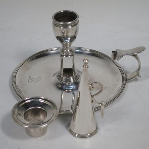 A handsome Antique Georgian Sterling Silver chamber-stick, having a round base, a cast plain scroll handle, an original removable dunce-cap extinguisher, an original removable nozzle, and with applied reed-edged borders. Made by John Emes of London in 1792. The dimensions of this fine hand-made antique silver chamberstick are diameter 14 cms (5.5 inches), height 10 cms (4 inches), and it weighs approx. 300g (9.7 troy ounces).    