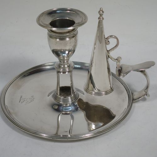 A handsome Antique Georgian Sterling Silver chamber-stick, having a round base, a cast plain scroll handle, an original removable dunce-cap extinguisher, an original removable nozzle, and with applied reed-edged borders. Made by John Emes of London in 1792. The dimensions of this fine hand-made antique silver chamberstick are diameter 14 cms (5.5 inches), height 10 cms (4 inches), and it weighs approx. 300g (9.7 troy ounces).    