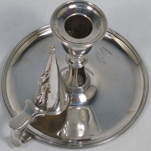 A handsome Antique Georgian Sterling Silver chamber-stick, having a round base, a cast plain scroll handle, an original removable dunce-cap extinguisher, an original removable nozzle, and with applied reed-edged borders. Made by John Emes of London in 1792. The dimensions of this fine hand-made antique silver chamberstick are diameter 14 cms (5.5 inches), height 10 cms (4 inches), and it weighs approx. 300g (9.7 troy ounces).    