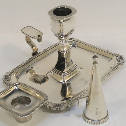 A handsome Antique Georgian Sterling Silver Regency style chamberstick, having a rectangular body with a gadroon & shell border, a side-handle with original removable snuffer, and an original drip-pan nozzle. This elegant antique silver chamberstick was made by Peter and William Bateman of London in 1812. The dimensions of this fine hand-made silver chamberstick are height 11 cms (4.25 inches), length 16 cms (6.25 inches), width 12.5 cms (5 inches), and with a total weight of approx. 352g (11.4 troy ounces). Please note that this item is part crested.