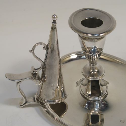 A very handsome Antique Georgian Sterling Silver chamber-stick, having an oval body, a plain scroll handle with thumb-piece, an original removable dunce-cap extinguisher, an original removable nozzle, and with applied reed-edged borders. This elegant silver chamberstick was made by William Abdy II of London in 1798. The dimensions of this fine hand-made antique silver chamberstick are length 16 cms (6.3 inches), width 14 cms (5.5 inches), height 8 cms (3 inches), and it weighs approx. 261g (8.4 troy ounces).   