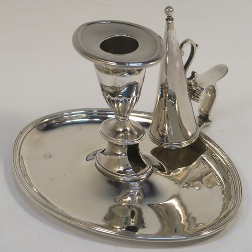 A very handsome Antique Georgian Sterling Silver chamber-stick, having an oval body, a plain scroll handle with thumb-piece, an original removable dunce-cap extinguisher, an original removable nozzle, and with applied reed-edged borders. This elegant silver chamberstick was made by William Abdy II of London in 1798. The dimensions of this fine hand-made antique silver chamberstick are length 16 cms (6.3 inches), width 14 cms (5.5 inches), height 8 cms (3 inches), and it weighs approx. 261g (8.4 troy ounces).   