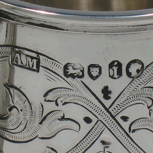 A very pretty Antique Victorian Sterling Silver christening mug, having a round body with straight sides, with hand-engraved floral and scroll decoration, applied bead-edged borers, a scroll handle, and sitting on a flat base. Made by the Alexander Macrae of London in 1864. The dimensions of this fine hand-made antique silver christening mug are height 9.5 cms (3.75 inches), diameter at lip 6.5 cms (2.5 inches), and it weighs approx. 157g (5 troy ounces).  