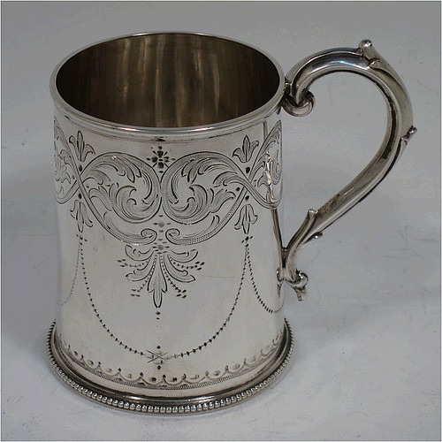 A very pretty Antique Victorian Sterling Silver christening mug, having a round body with straight sides, with hand-engraved floral and scroll decoration, applied bead-edged borers, a scroll handle, and sitting on a flat base. Made by the Alexander Macrae of London in 1864. The dimensions of this fine hand-made antique silver christening mug are height 9.5 cms (3.75 inches), diameter at lip 6.5 cms (2.5 inches), and it weighs approx. 157g (5 troy ounces).  