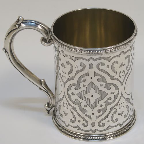 A very pretty Antique Victorian Sterling Silver christening mug, having a round body with straight sides, with hand-engraved scroll decoration, a gold-gilt interior, applied bead-edged borders, a scroll handle, and sitting on a flat base. This beautiful antique silver christening mug was made by Henry Holland of London in 1868. The dimensions of this fine hand-made antique silver mug are height 8 cms (3 inches), diameter at lip 6 cms (2.3 inches), and it weighs approx. 111g (3.6 troy ounces).   