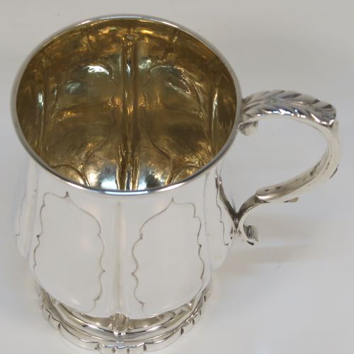 An elegant Antique early Victorian Sterling Silver christening mug, having a bellied body with hand-chased fluted and panelled decoration, a scroll handle with anthemion leaf thumb-piece, a gold-gilt interior, and all sitting on a pedestal foot. This handsome silver christening mug was made by the Edward Burton of London in 1837. The dimensions of this fine hand-made antique silver christening mug are height 10 cms (4 inches), length 10 cms (4 inches), and it weighs approx. 141g (4.5 troy ounces).   