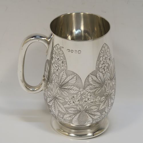 A really beautiful Antique Victorian Sterling Silver christening mug, having a round body with straight tapering sides and tucked under belly, with hand-engraved ferns floral decoration, a plain loop handle, and all sitting on a pedestal foot. This fantastic silver christening mug was made Stephen Smith of London in 1873. The dimensions of this fine hand-made antique silver christening mug are height 11 cms (4.25 inches), diameter at lip 6 cms (2.25 inches), and it weighs approx. 182g (5.9 troy ounces).   