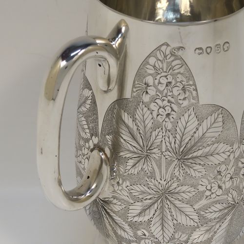 A really beautiful Antique Victorian Sterling Silver christening mug, having a round body with straight tapering sides and tucked under belly, with hand-engraved ferns floral decoration, a plain loop handle, and all sitting on a pedestal foot. This fantastic silver christening mug was made Stephen Smith of London in 1873. The dimensions of this fine hand-made antique silver christening mug are height 11 cms (4.25 inches), diameter at lip 6 cms (2.25 inches), and it weighs approx. 182g (5.9 troy ounces).   