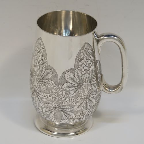 A really beautiful Antique Victorian Sterling Silver christening mug, having a round body with straight tapering sides and tucked under belly, with hand-engraved ferns floral decoration, a plain loop handle, and all sitting on a pedestal foot. This fantastic silver christening mug was made Stephen Smith of London in 1873. The dimensions of this fine hand-made antique silver christening mug are height 11 cms (4.25 inches), diameter at lip 6 cms (2.25 inches), and it weighs approx. 182g (5.9 troy ounces).   